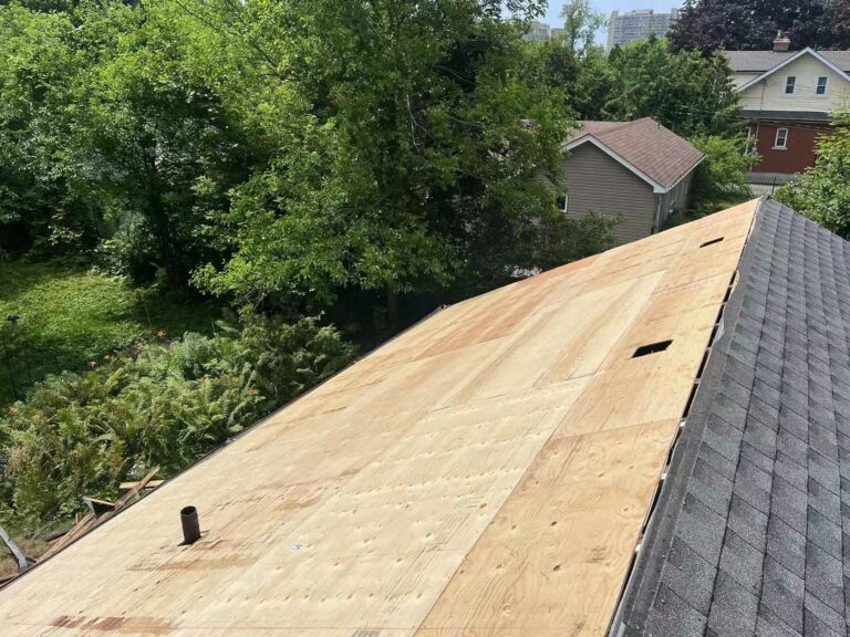 Roof stripped to the wooden deck, with old shingles removed