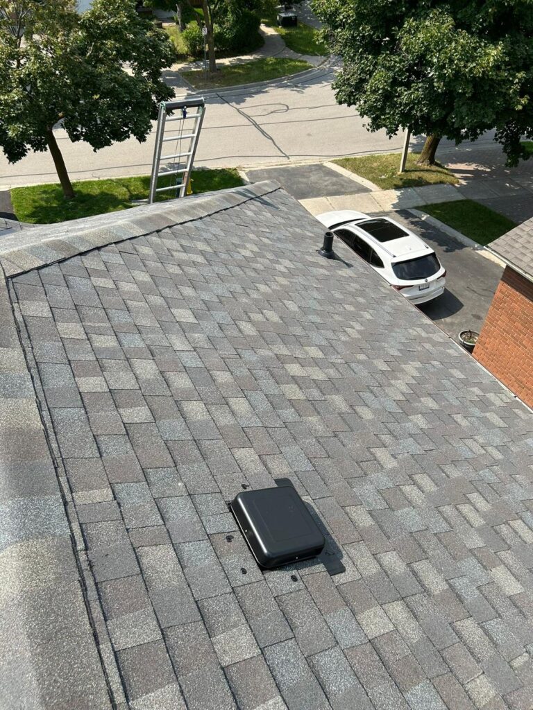 Finished grey architectural shingle roof with new vents