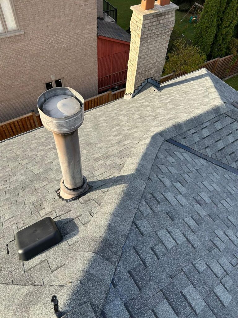 New shingle roof with a vent stack and roof vent